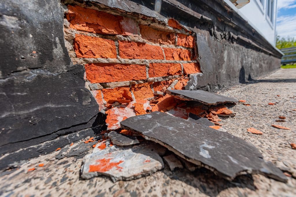 Frost Damage to red rubber bricks.